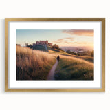 Elegant gold-framed landscape artwork showcasing a majestic castle surrounded by lush greenery, highlighted by a white mat for added depth and sophistication.