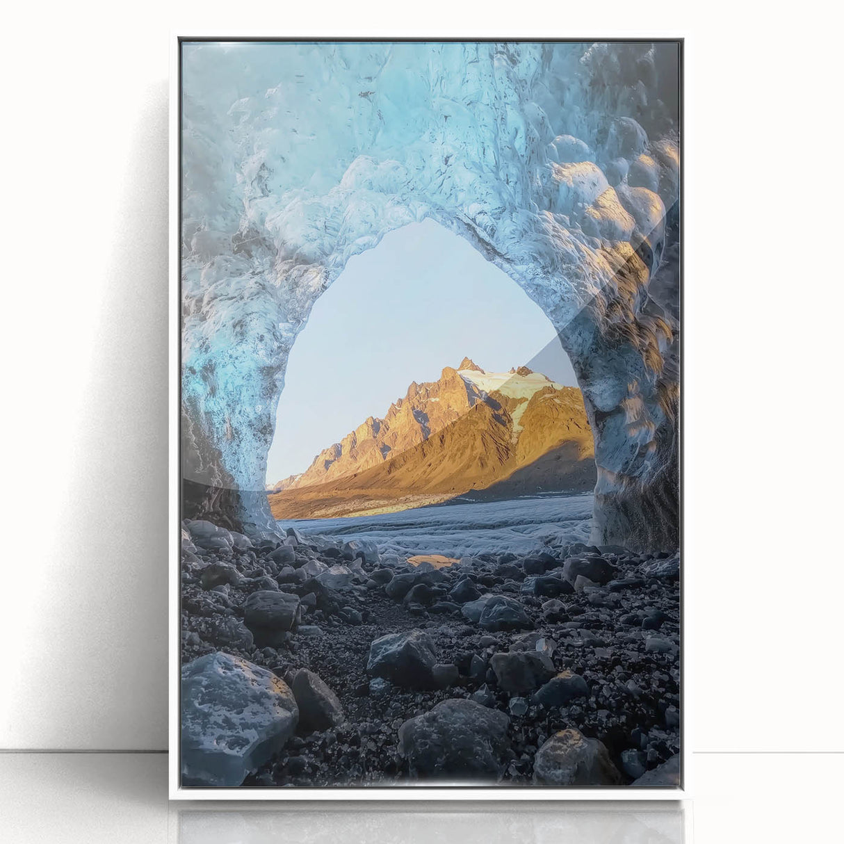 Framed acrylic artwork depicting a serene landscape with caves, featuring rich colors and intricate details, displayed in a sleek white frame for a modern touch.
