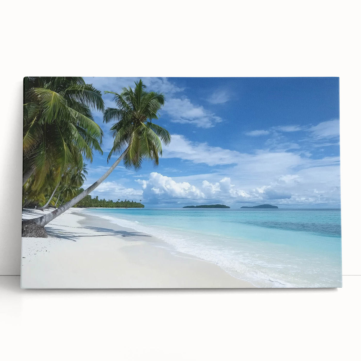 Stretched canvas artwork depicting a serene beach landscape with vibrant blue skies and soft sandy shores, perfect for coastal decor in modern interiors.
