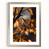 Textured art depicting abstract fall scenery in earthy tones on a silver-framed canvas, ideal for bedroom decor.