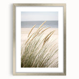 Textured abstract art print in silver frame, featuring dynamic swirls in muted gray tones, ideal for modern bedroom ambiance.