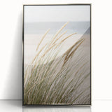 Mid-century modernist art depicting abstract shapes in pastel colors on a silver-framed acrylic.