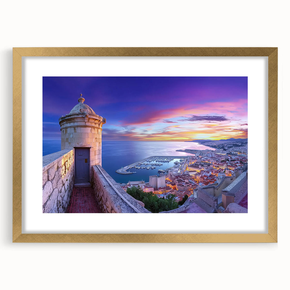 Elegant gold-framed landscape artwork featuring a picturesque castle scene, enhanced by a mat for added depth, perfect for home decor or gallery displays.