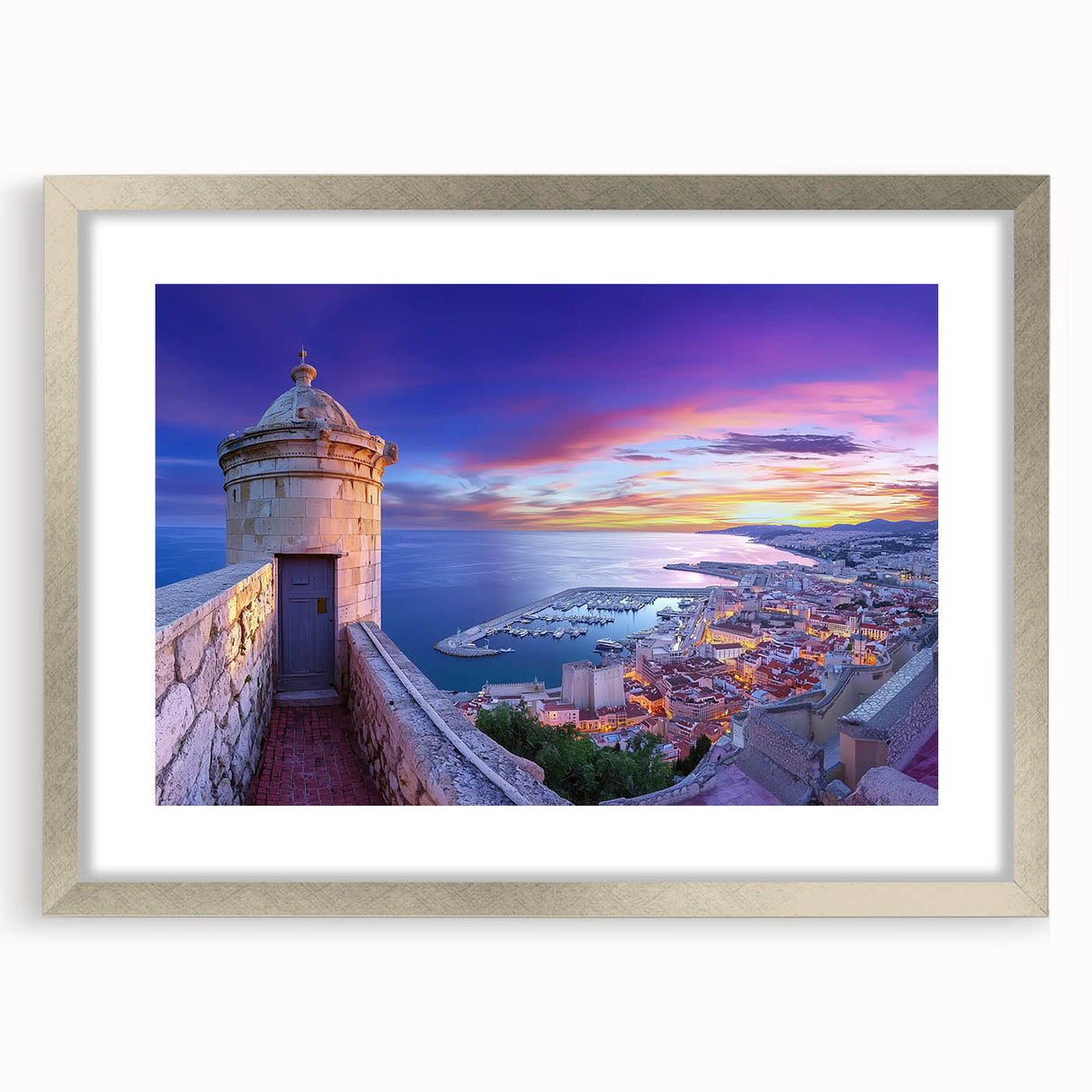 Framed silver landscape artwork depicting a majestic castle surrounded by lush greenery, highlighted with a white mat, perfect for elegant home decor.