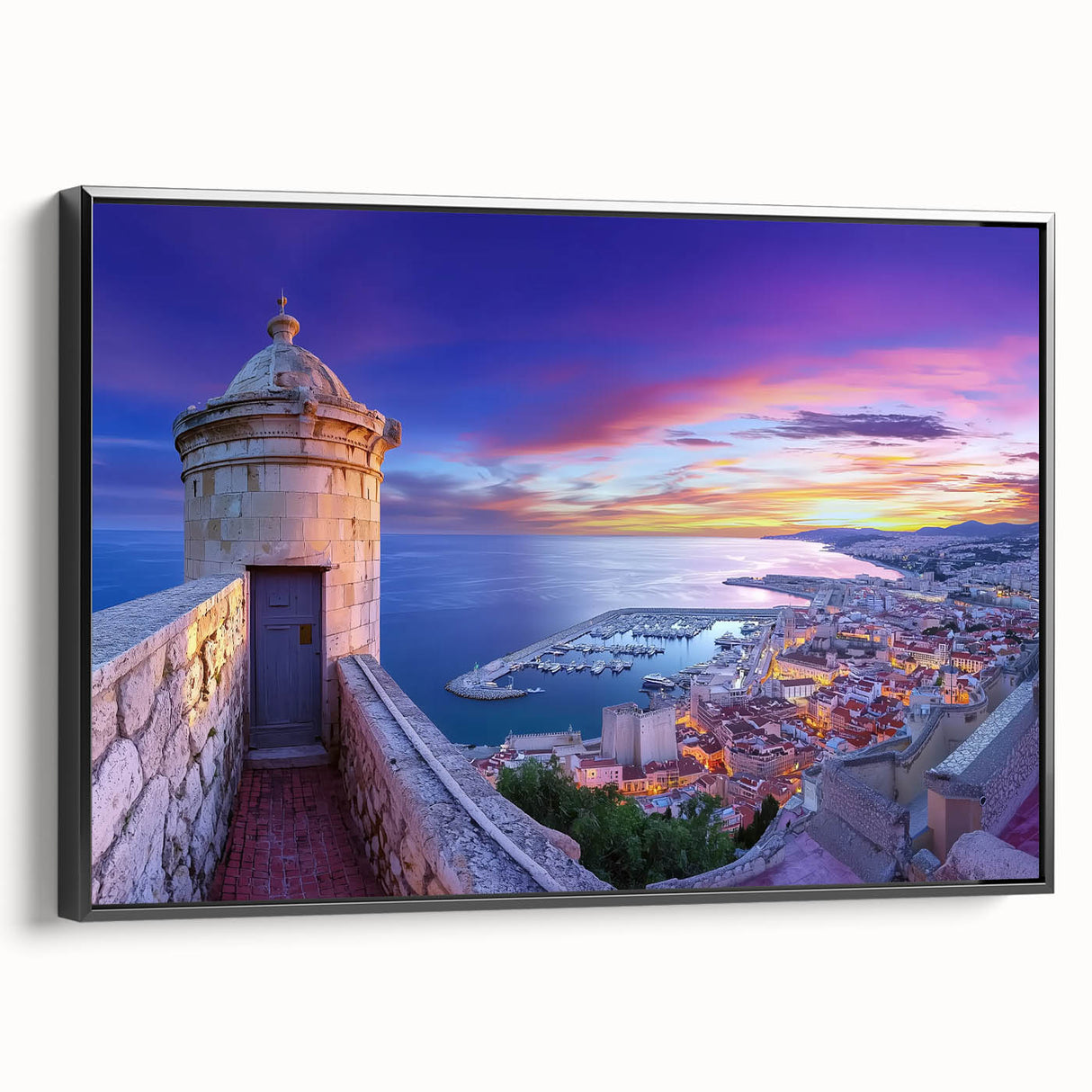 Framed canvas artwork showcasing a scenic landscape with a majestic castle, presented in a sleek black frame, ideal for home decor and enhancing interior aesthetics.