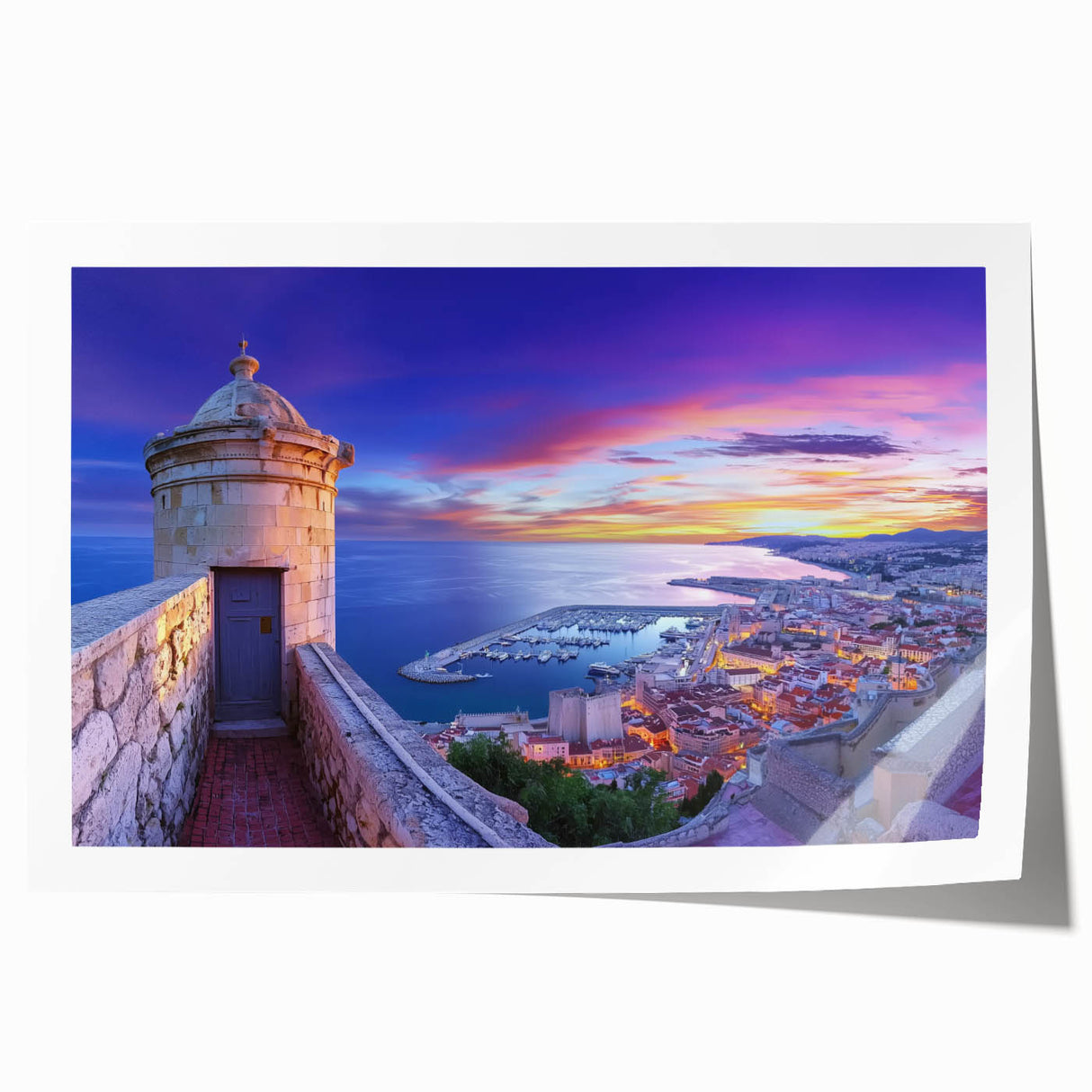 Rolled print of a stunning landscape featuring a medieval castle surrounded by lush greenery and vibrant skies, elegantly packaged in a protective tube for easy display.