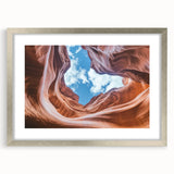 Landscape artwork depicting a scenic canyon framed in silver with a mat, showcasing vibrant colors and intricate details, ideal for home decor enhancement.