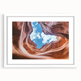 Framed landscape artwork depicting vibrant canyons with rich colors, surrounded by a white mat, showcasing a modern aesthetic perfect for home decor.