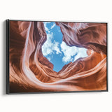 Framed canvas artwork depicting a stunning canyon landscape in vibrant colors, featuring a sleek black frame that complements the scene. Ideal for modern home decor.