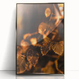 Mid-century modernist art featuring an abstract fall landscape in warm orange and brown tones, framed in silver acrylic.