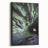 Framed canvas artwork depicting a serene cave landscape with rich textures and deep colors, showcasing a black frame from a side view, ideal for home decor.