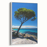 Framed canvas print of a dramatic cliff landscape, showcasing vibrant colors and intricate details, displayed against a white wall for an elegant home decor accent.