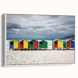 Framed canvas artwork depicting a serene beach landscape with gentle waves and a clear blue sky, presented in a sleek white frame, perfect for coastal home decor.