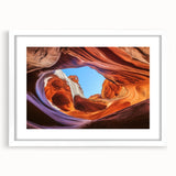 Landscape art print featuring a breathtaking canyon scene, framed with a white mat, showcasing vibrant earth tones and intricate details, perfect for home decor.