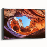 Framed canvas artwork showcasing a stunning landscape of canyons with rich earthy tones, ideal for home decor, featuring a sleek black frame from a side view.