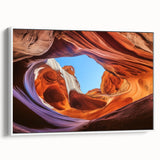 Framed canvas artwork showcasing a stunning landscape of canyons, highlighted in warm earth tones. The piece features a sleek white frame, enhancing the natural beauty of the scene, perfect for home decor enthusiasts looking to add a touch of nature to their interiors.
