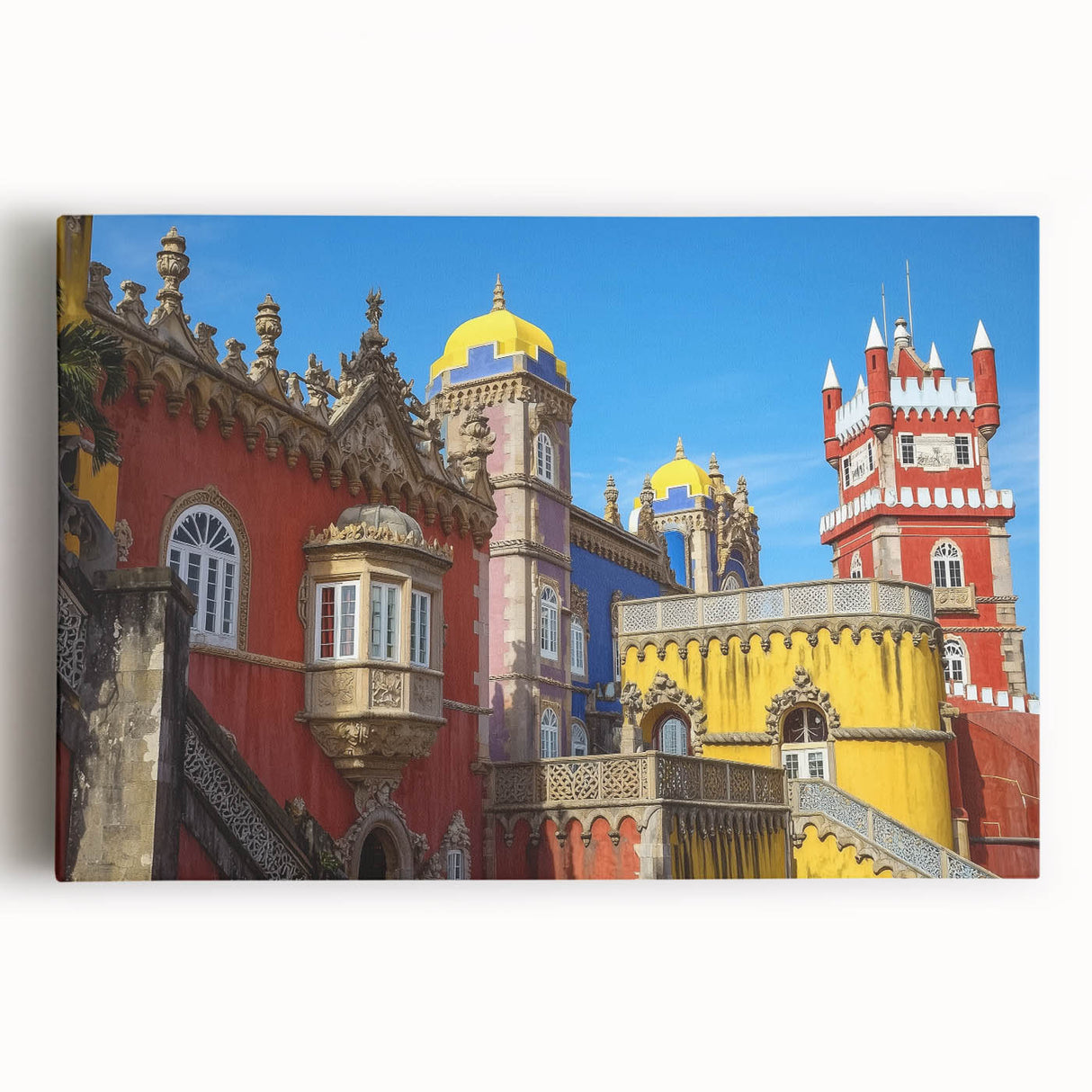 Stretched canvas artwork depicting a scenic landscape of a majestic castle surrounded by lush greenery and a clear blue sky, perfect for home decor.