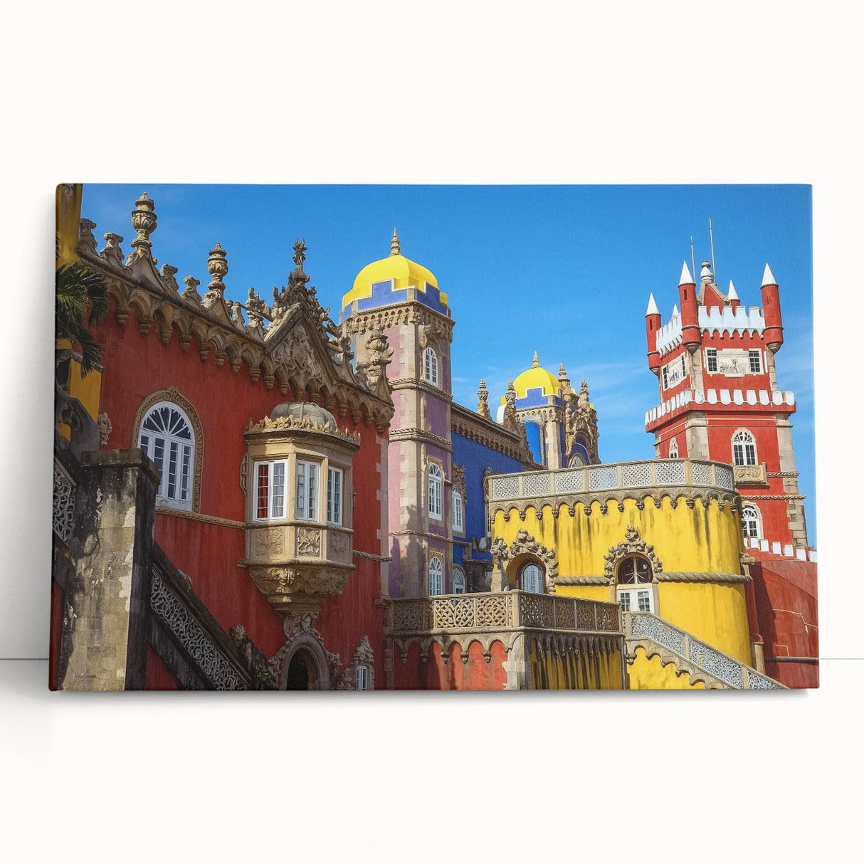 Stretched canvas artwork depicting a scenic landscape with a majestic castle surrounded by lush greenery and a clear blue sky, ideal for home decor.