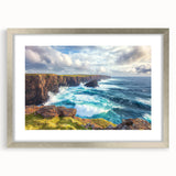 Framed landscape artwork showcasing a dramatic cliff scene with vibrant colors, set in a sleek silver frame with a white mat, perfect for modern decor.