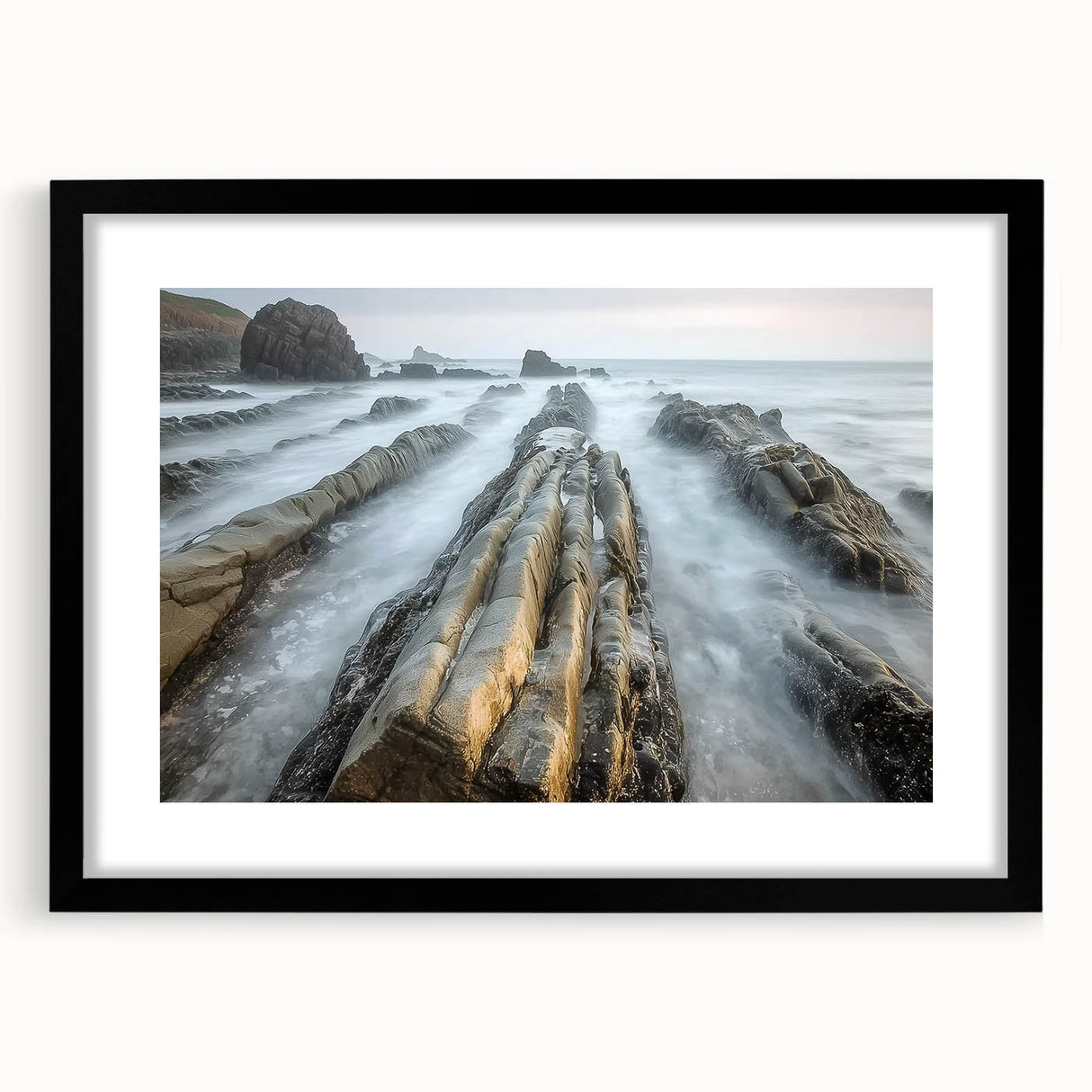 Black-framed landscape artwork featuring serene beach scenery with soft waves and golden sands, elegantly matted for a polished display, perfect for coastal home decor.