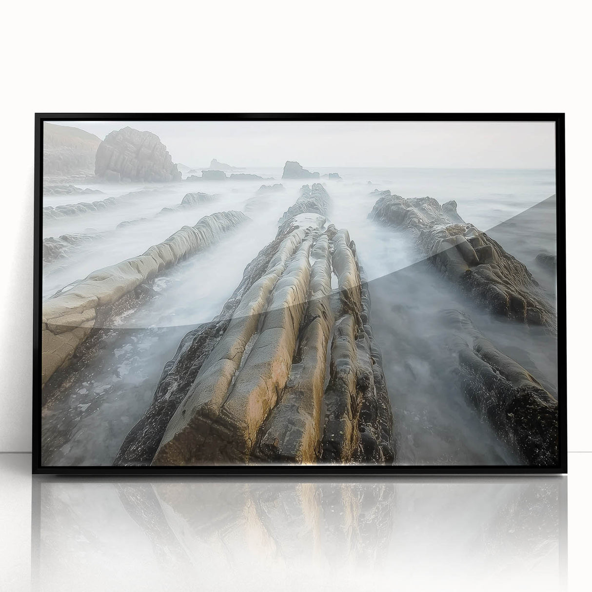 Framed acrylic artwork depicting a serene beach landscape with gentle waves and a clear blue sky, presented in a sleek black frame for elegant home decor.