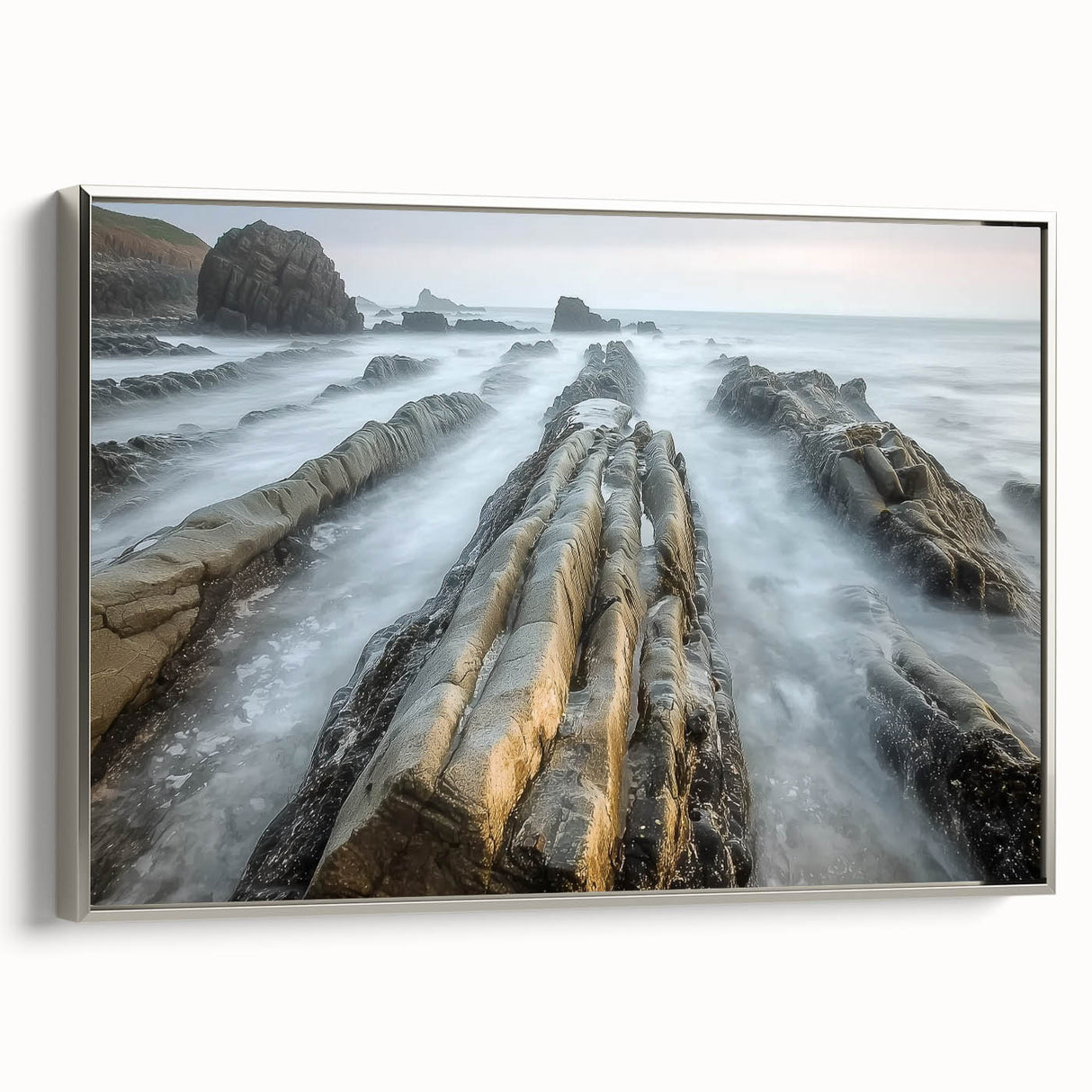 Framed canvas print of a serene beach landscape, showcasing soft pastel colors and tranquil waves, with a sleek silver frame enhancing its elegance, ideal for coastal decor.