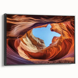 Framed canvas art depicting a stunning landscape of canyons, featuring rich earthy tones and intricate details, presented in a sleek black frame, perfect for home decor.