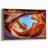 Framed canvas artwork showcasing a stunning landscape of canyons, featuring a rich color palette and a sleek silver frame, ideal for enhancing modern home decor.