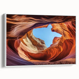 Framed landscape canvas print depicting vibrant canyons with rich, earthy tones. The artwork features a white frame, enhancing its natural beauty and elegance. Perfect for home decor, this piece adds a touch of nature-inspired art to any room.