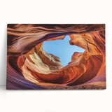 Stretched canvas artwork showcasing a stunning landscape of canyons at sunset, featuring vibrant oranges and purples, perfect for home decor or art enthusiasts.