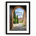 Elegant black-framed landscape print showcasing a majestic castle surrounded by lush greenery, presented with a white mat for a refined finish, perfect for home decor.