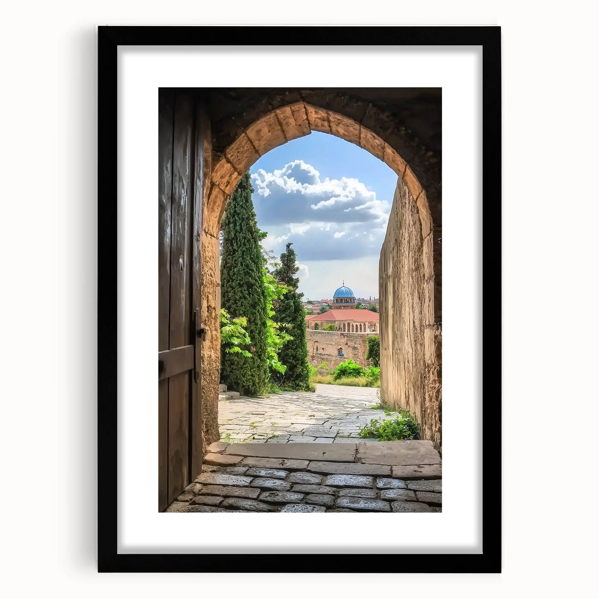 Elegant black-framed landscape print showcasing a majestic castle surrounded by lush greenery, presented with a white mat for a refined finish, perfect for home decor.