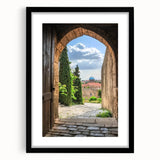 Elegant black-framed landscape print showcasing a majestic castle surrounded by lush greenery, presented with a white mat for a refined finish, perfect for home decor.