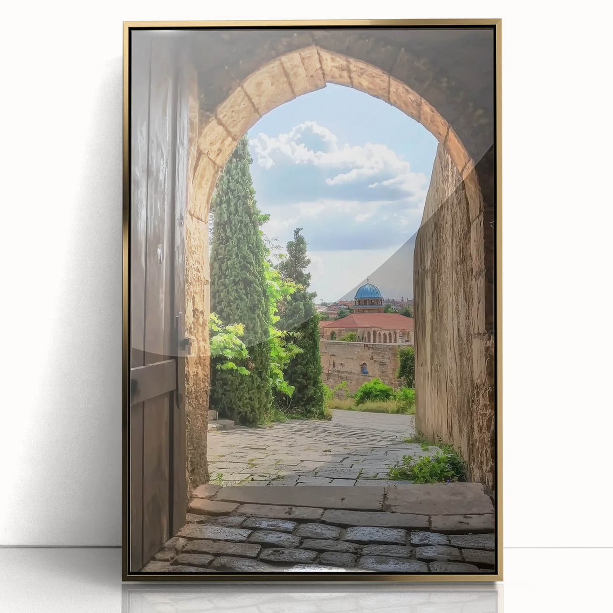 Framed acrylic artwork showcasing a majestic landscape with a castle surrounded by lush greenery, highlighted by a gold frame that enhances its elegance.