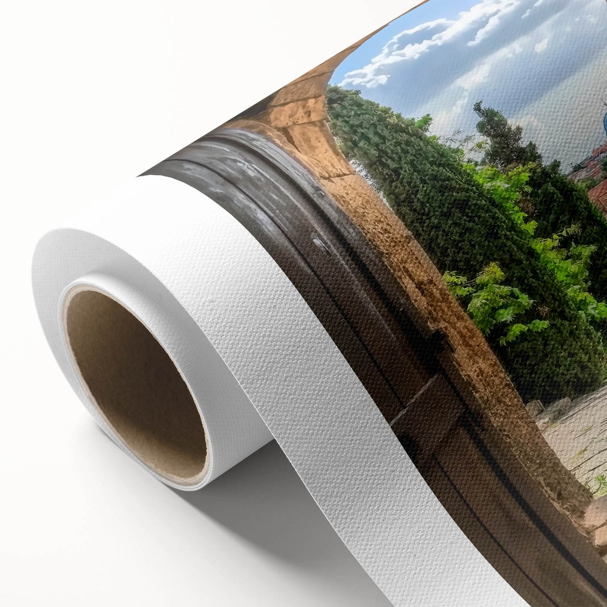 Rolled canvas artwork depicting a serene landscape with a majestic castle, featuring vibrant colors and intricate details, packaged securely in a protective cardboard tube.