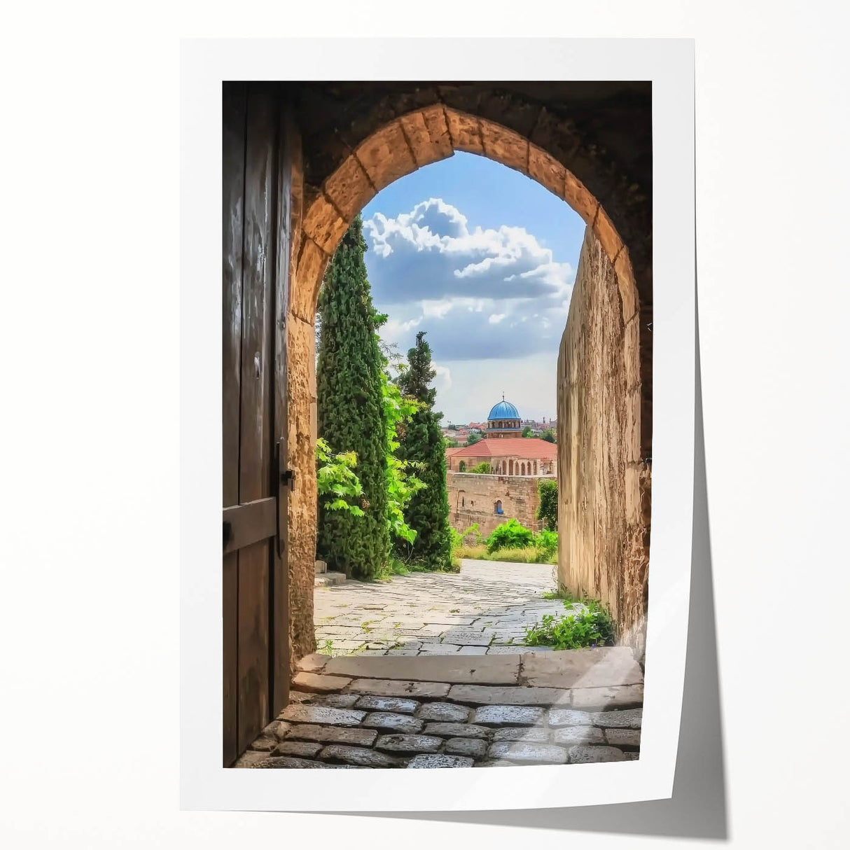 Rolled print showcasing a stunning landscape featuring a majestic castle surrounded by lush greenery and a serene blue sky, ideal for home decor.