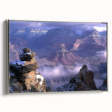 Framed canvas artwork depicting a stunning landscape of canyons, featuring rich earthy tones and intricate details, set against a sleek silver frame for a modern aesthetic. This piece enhances any interior space with its captivating natural scenery and elegant presentation.