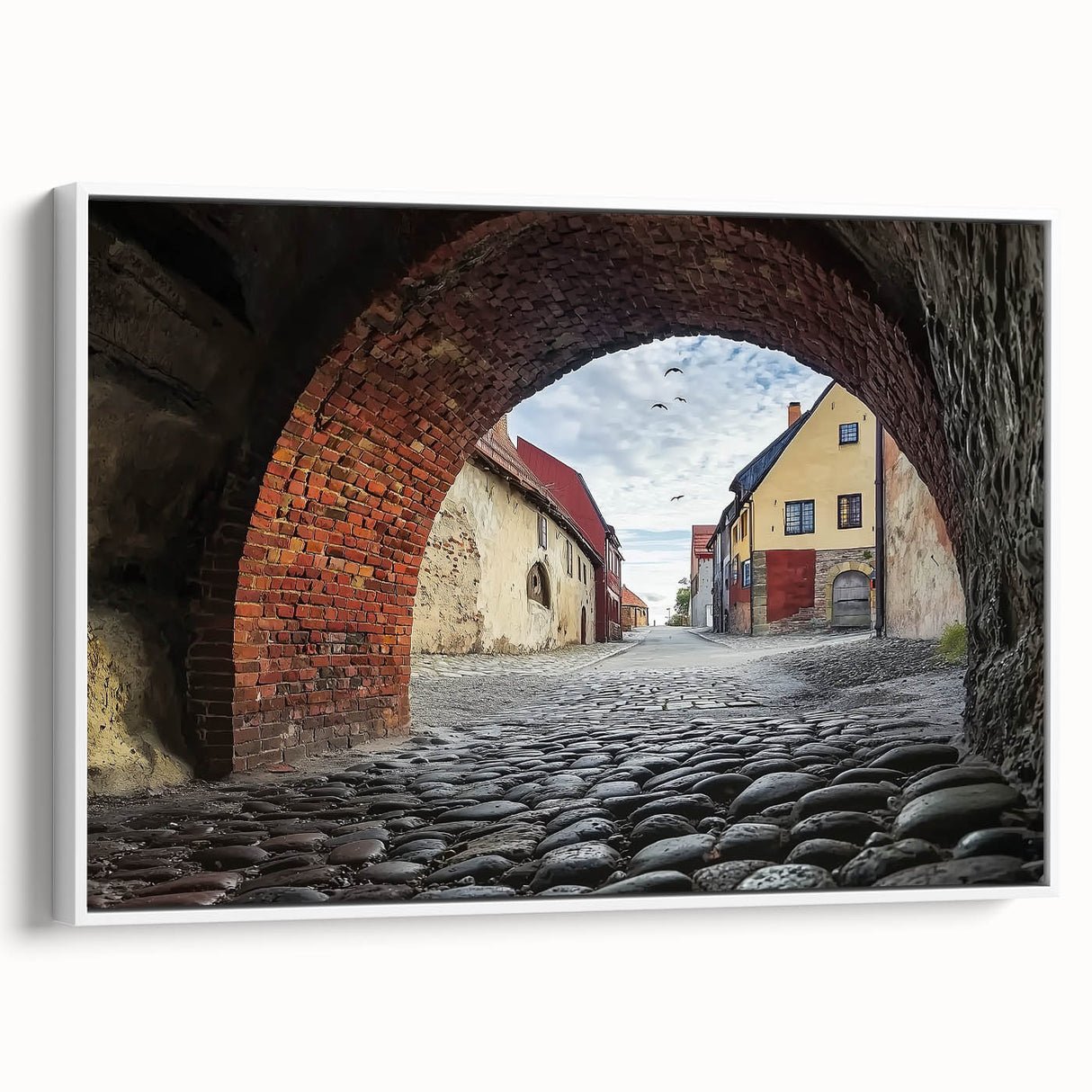Framed canvas artwork displaying a picturesque landscape featuring a majestic castle surrounded by lush greenery, set against a bright blue sky. The white frame enhances the overall aesthetic, making it an elegant choice for home decor. This enchanting piece adds a touch of sophistication and charm to any room, perfect for art lovers seeking to create a serene atmosphere.