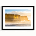 Framed landscape artwork depicting dramatic cliffs with a black mat, showcasing vibrant colors and intricate details against a modern home decor setting.