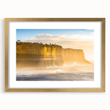 Elegant gold-framed landscape artwork featuring dramatic cliffs and serene skies, with a white mat that enhances its natural beauty, perfect for home decor.
