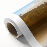 Vibrant rolled canvas artwork showcasing a dramatic cliff landscape with rich colors; ideal for home decor, presented in a protective cardboard tube.