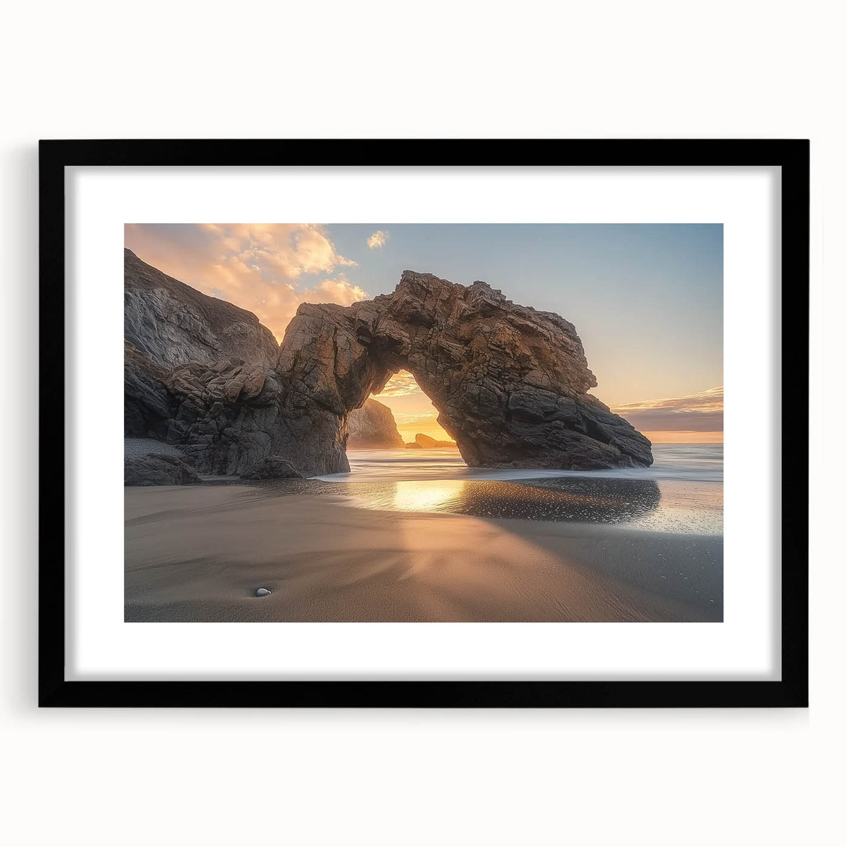 Black-framed landscape artwork showcasing a serene beach scene with gentle waves and soft sand, set against a clear blue sky, perfect for home decor.