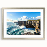 Framed landscape artwork depicting majestic cliffs, elegantly bordered with a silver mat, showcasing vibrant colors and intricate details for a stunning decor accent.
