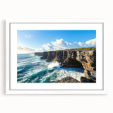 Framed landscape artwork showcasing majestic cliffs in a serene setting, accented by a white mat, perfect for enhancing home decor and interior aesthetics.