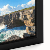 Close-up of a framed canvas print depicting a stunning cliff landscape with vibrant colors and intricate details, perfect for enhancing home decor aesthetics.