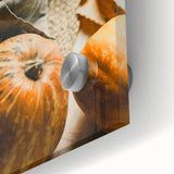 Large abstract wall art depicting fall foliage in orange and red tones on acrylic glass, suitable for dining room decor.