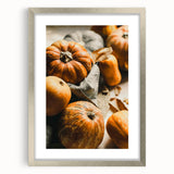 Textured art depicting abstract fall foliage in orange and red tones on a silver-framed canvas, suitable for bedroom decor.