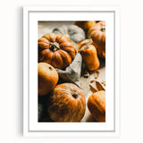 Abstract art print featuring warm autumnal hues on a white framed canvas, ideal for dining room decor.