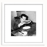 Abstract art print featuring stylized food and people motifs in muted colors on a white framed mat.