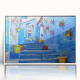 Large acrylic print of a Moroccan landscape in muted earth tones, framed in white, suitable for modern art wall decor.